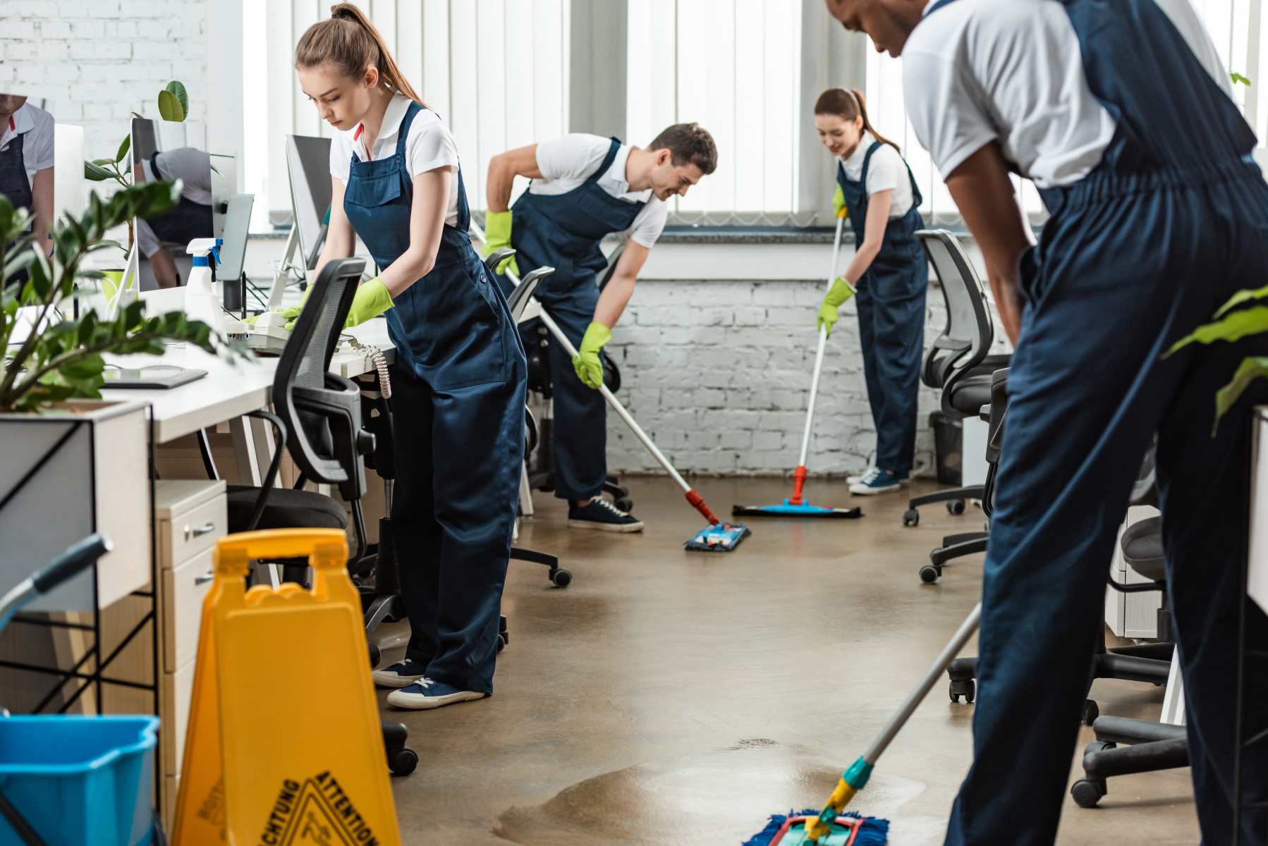 multicultural team of young cleaners washing floor multicultural team of young cleaners washing floor